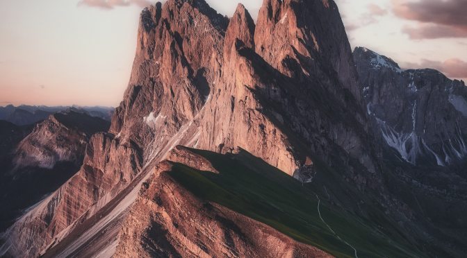 a mountain range under a beige sky